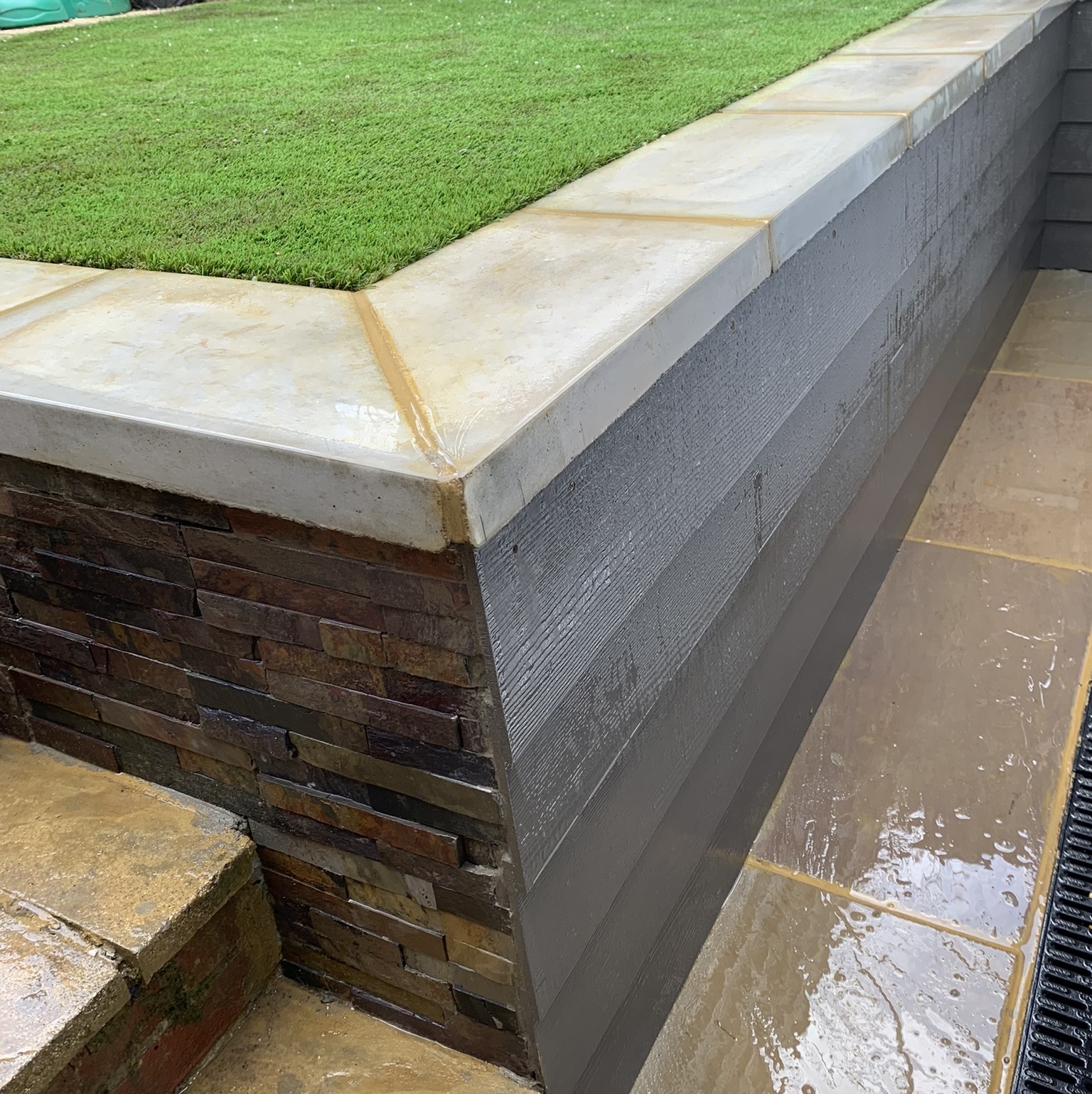 Fibre Board Cladding and Split Faced Tiles Retaining Wall